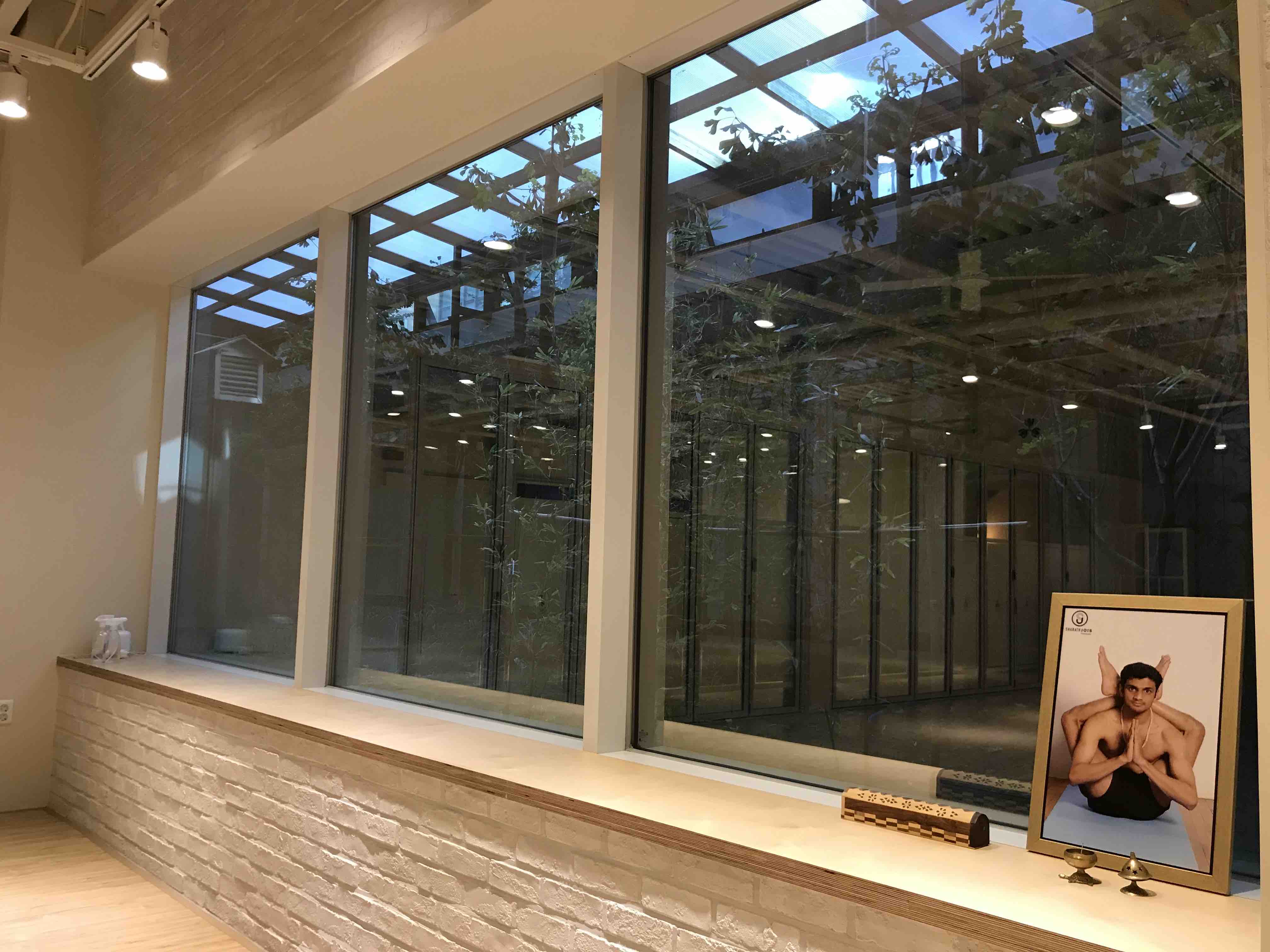Window and Sarath Jois portrait at Tristhana Yoga shala